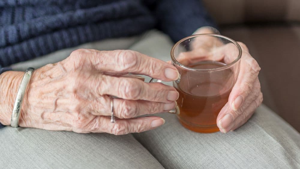 Elderly hands holding tea