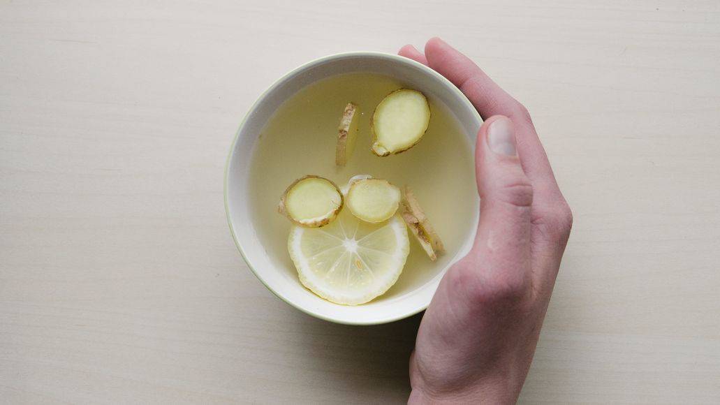 Sick person holding ginger tea